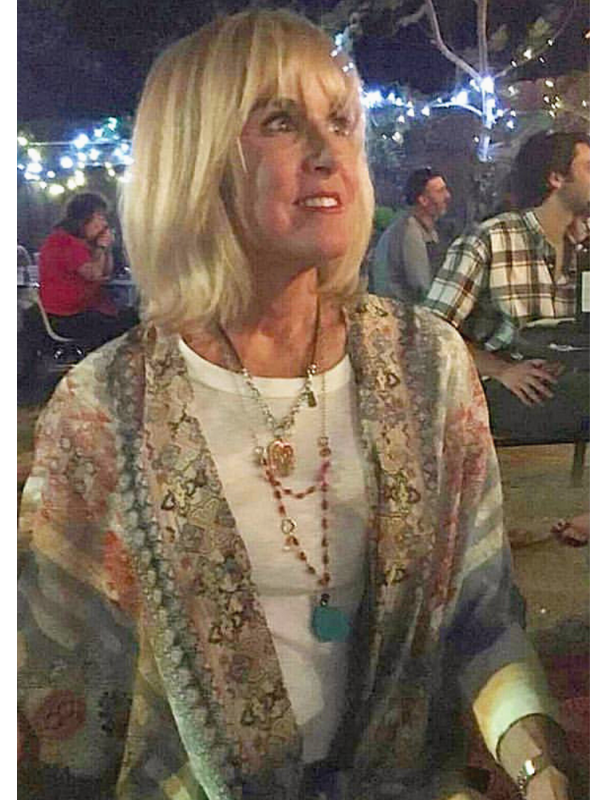 layered necklaces on blonde female at outside party